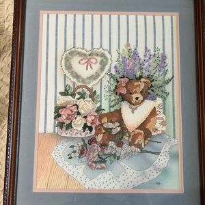 Custom framed Teddy Bear Cross Stitch with Floral Accents 1998. 19.5” x 23.25”